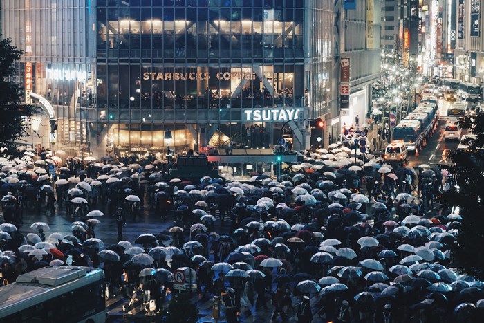 Shibuya Crossing in Tokyo during a rainy evening