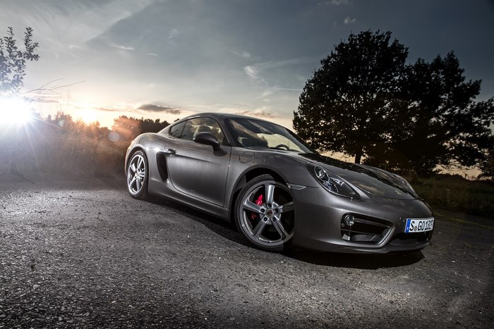 Porsche Cayman S on a dirt road at sunset