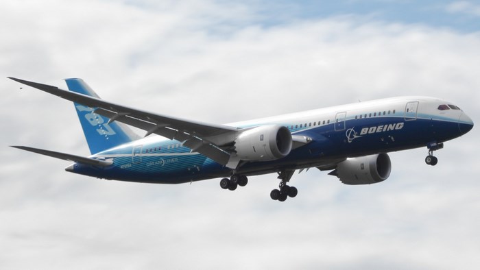 Boeing 787 Dreamliner Flying in Cloudy Sky
