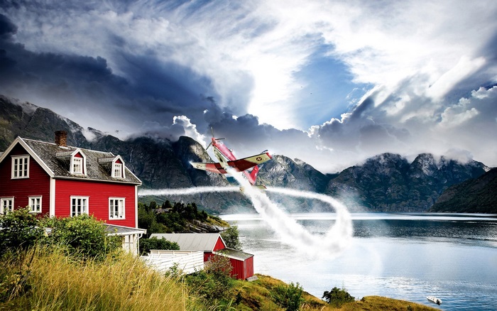 Airplane performing aerobatics over a Norwegian fjord