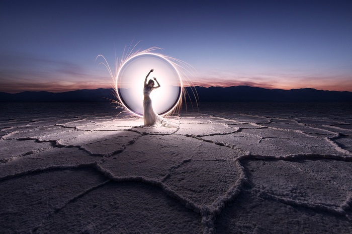 Woman in a dress in a light circle on a salt flat