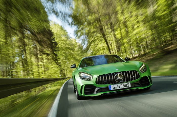 Green Mercedes-AMG GT R driving on a forest road