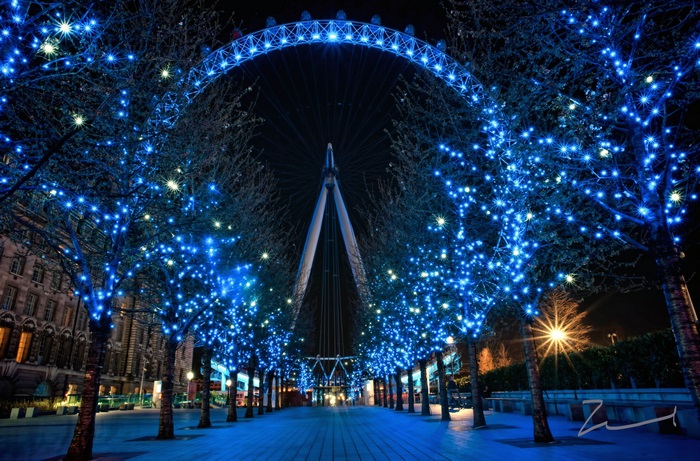 London Eye illuminated with blue lights at night