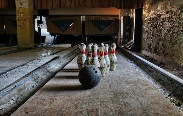 Abandoned bowling alley with pins and ball