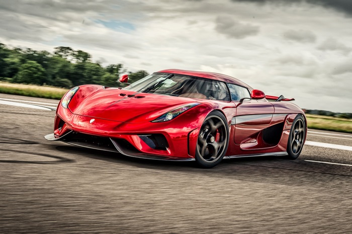 Red Koenigsegg Regera driving on a road