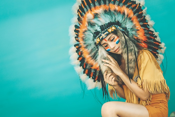 Woman in Native American Headdress with Face Paint