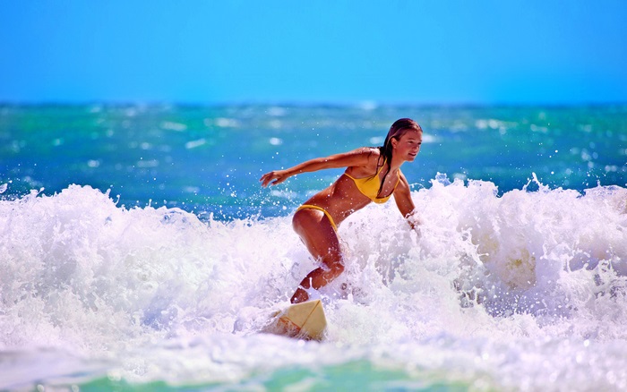 Surfer Riding a Wave in Bright Sunny Day 4K
