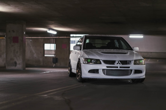 White Mitsubishi Lancer Evolution VIII in parking garage