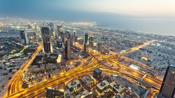 Dubai cityscape with highways and skyscrapers at dusk