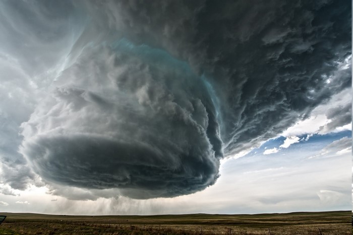 Stormy sky with a supercell thunderstorm over a field