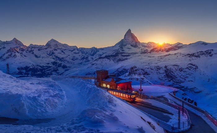 Sunset over the Matterhorn with a train station