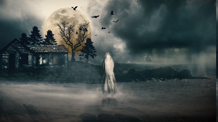 Ghostly figure by abandoned house under a full moon