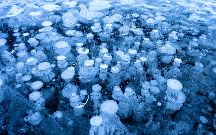 Frozen lake with trapped air bubbles