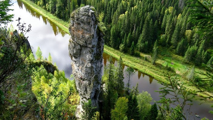 Tall Rock Formation Overlooking River and Forest