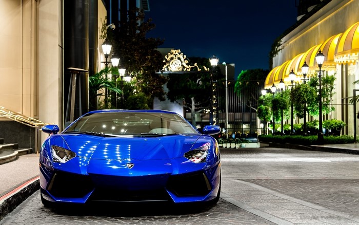 Blue Lamborghini Aventador parked at night