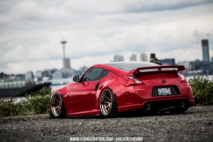 Red Nissan 370Z with custom wheels in Seattle