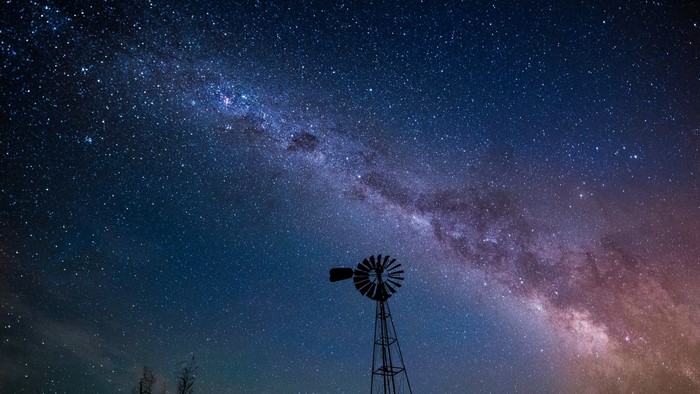 Milky Way over a windmill at night