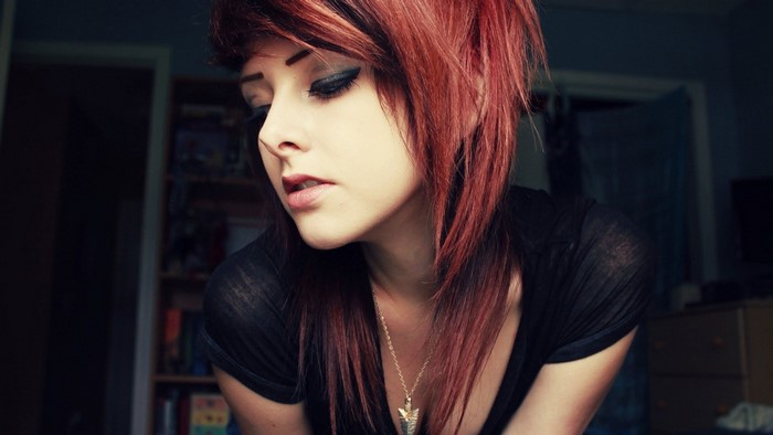 Redhead emo woman with necklace indoors