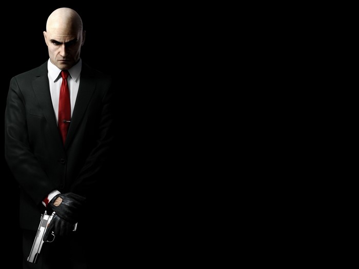 Agent 47 from Hitman holding a pistol