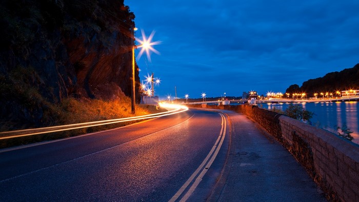 Nighttime Road Along Waterfront with Streetlights