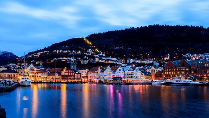 Bergen Norway waterfront at dusk with boats and city lights