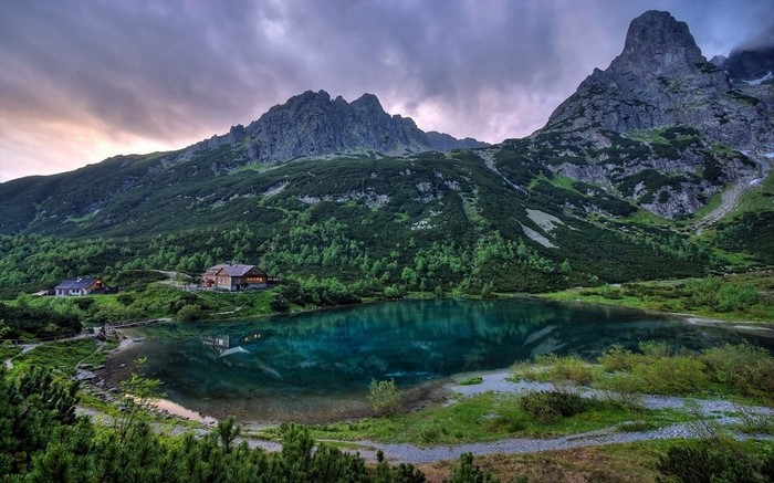 Mountain lake with cabins and forest in Slovakia