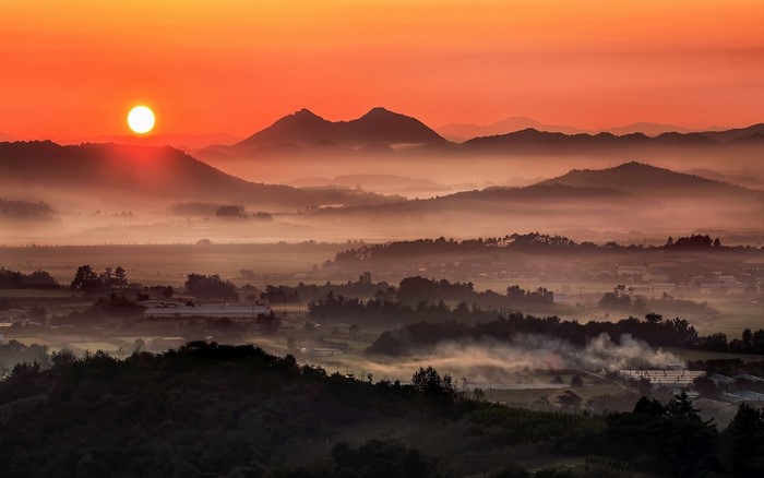 Sunrise over misty valley and mountains in South Korea
