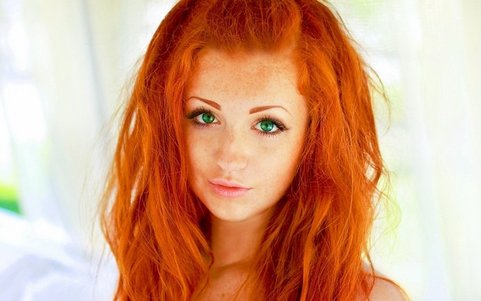 Redhead woman with green eyes and freckles