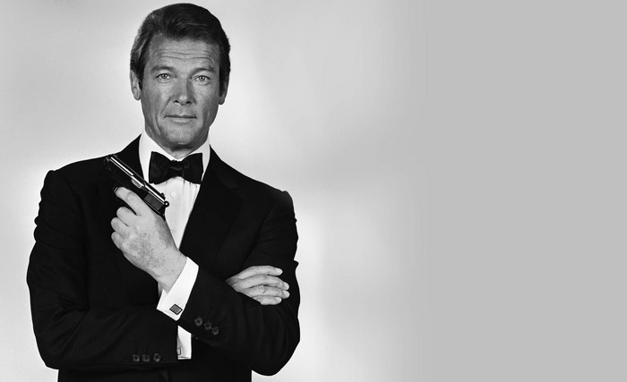 Roger Moore as James Bond holding a gun
