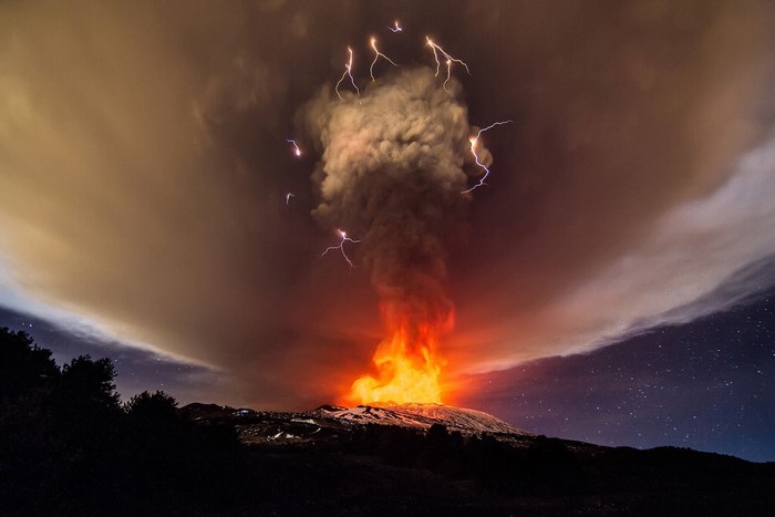 Volcano eruption with lightning and smoke at night