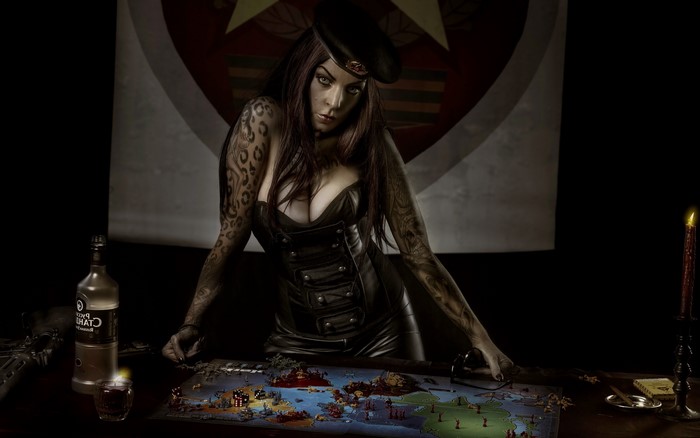 Woman with tattoos and vodka playing a board game