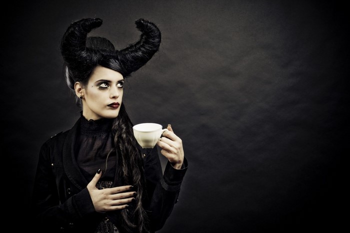 Gothic woman with horns holding a teacup