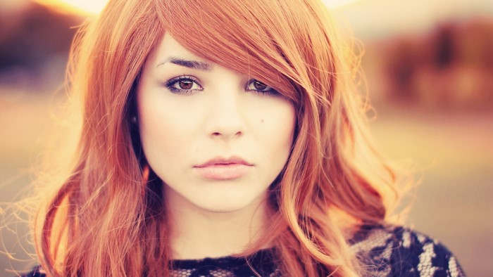 Redhead woman with hazel eyes wearing black clothing