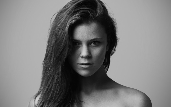 Monochrome portrait of a woman with freckles and long hair