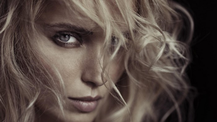 Close-up portrait of a blonde woman with blue eyes