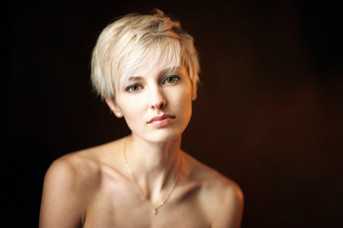 Woman with short blonde hair and green eyes