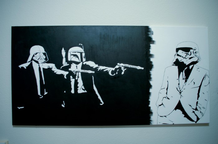 Darth Vader and Boba Fett from Star Wars pointing guns at Stormtrooper