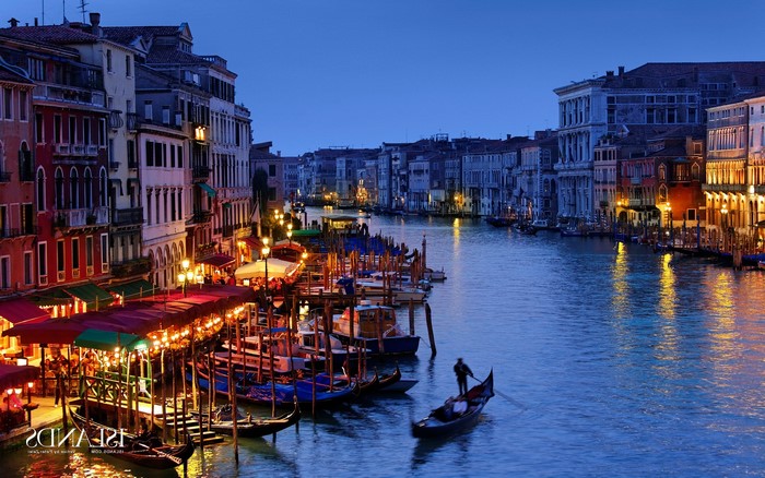 Venice canal at dusk with gondola and buildings