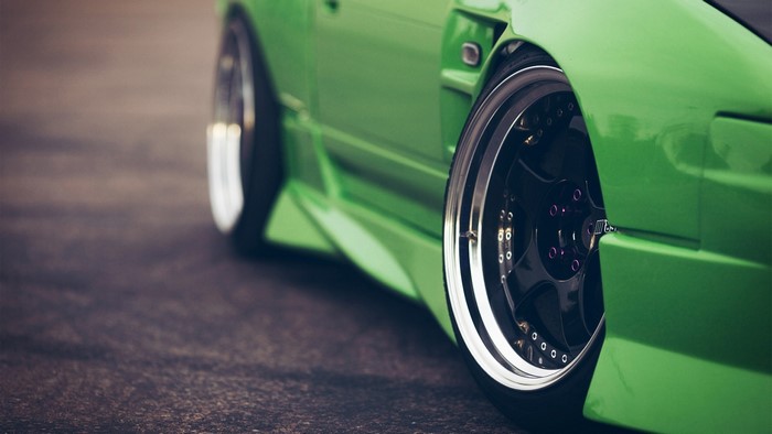 Green car with custom wheels