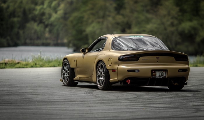 Gold Mazda RX-7 sports car on a track