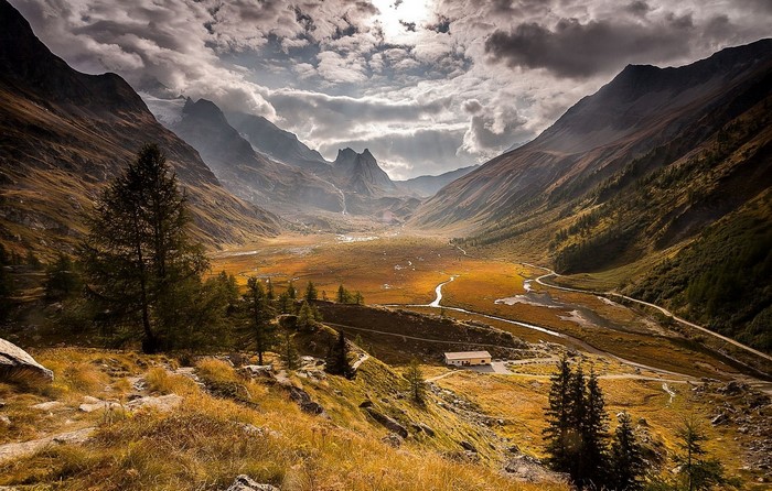 Valley with mountains, dry grass, and a road