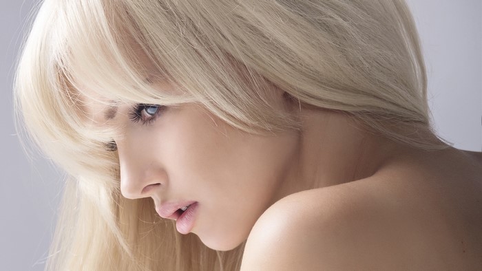 Portrait of a Blonde Woman with Smooth Skin and Blue Eyes
