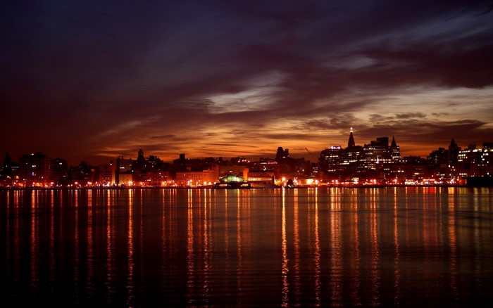 City skyline at night with water reflections