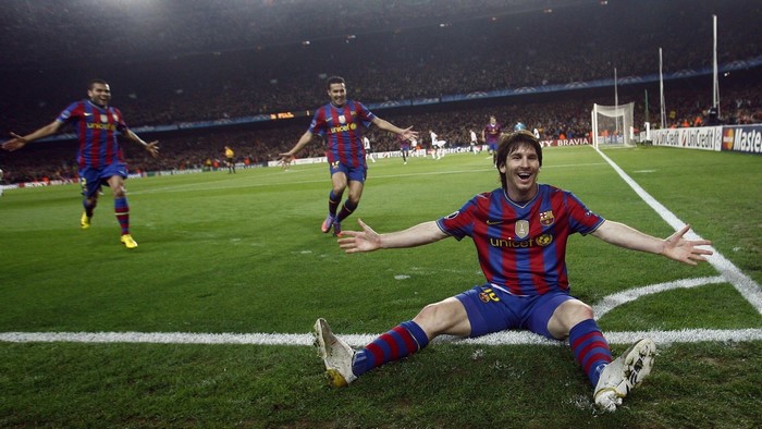 Lionel Messi and teammates from FC Barcelona celebrating on a soccer field