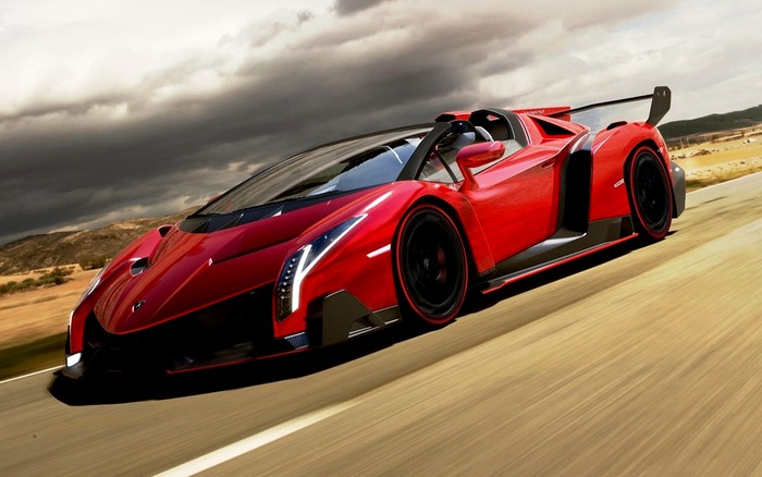 Red Lamborghini Veneno driving on a road