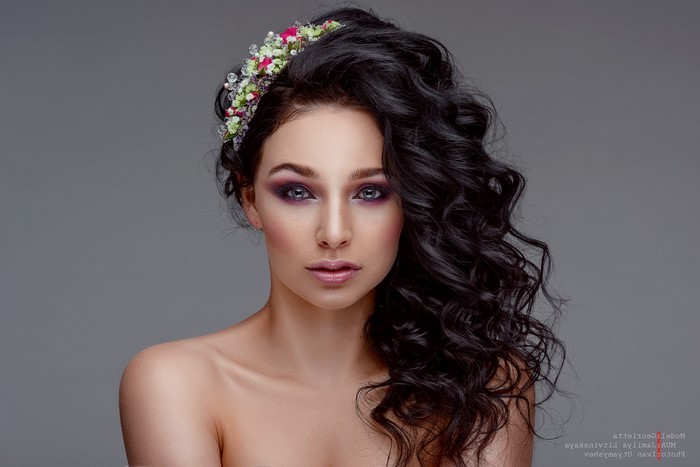 Portrait of Woman with Curly Black Hair and Flower
