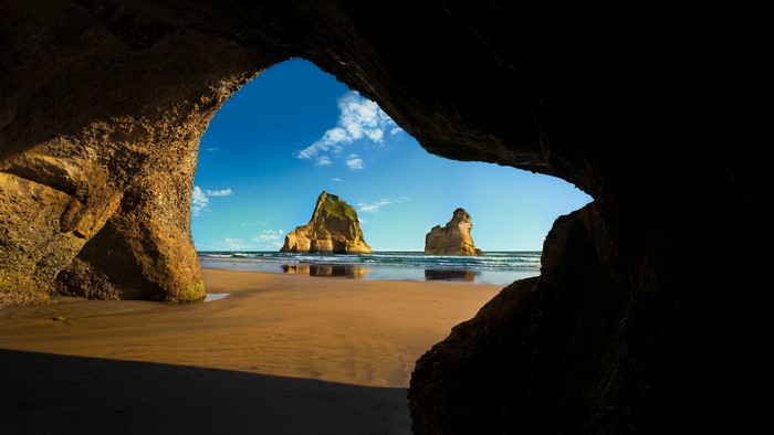 Scenic Beach View Through a Coastal Cave