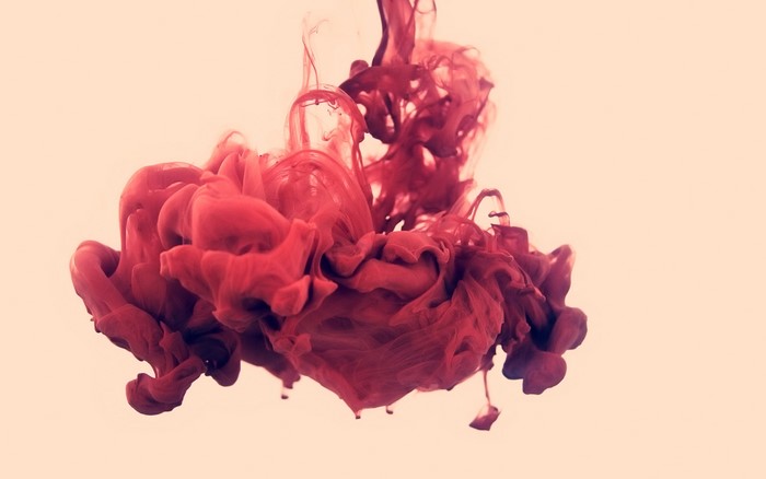 Red ink dissolving in water by Alberto Seveso