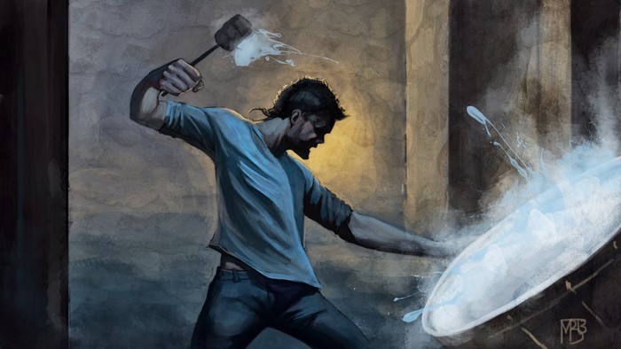 Man smashing a large object with a hammer