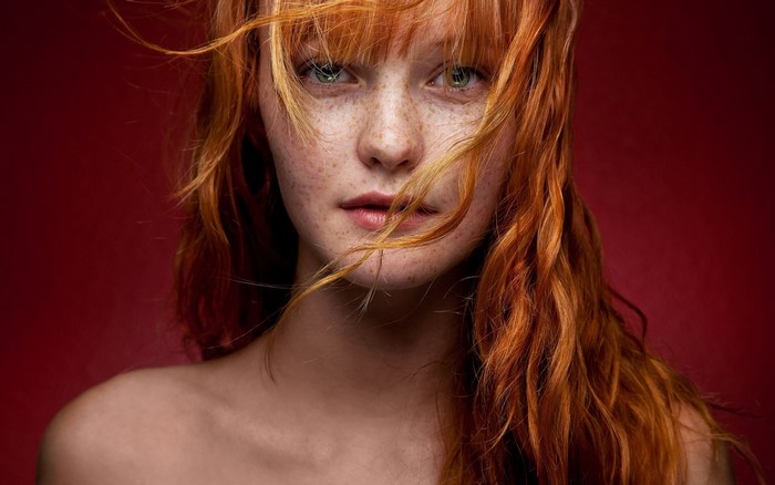 Redhead woman with freckles and green eyes